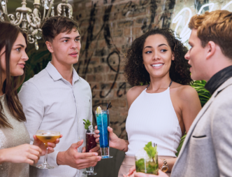 Group of people talking holding drinks